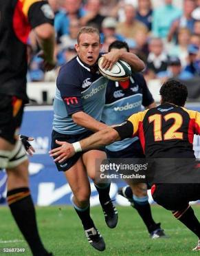 PRETORIA, SOUTH AFRICA -  APRIL 23:  (TOUCHLINE IMAGES ARE AVAILABLE TO CLIENTS IN THE UK, USA AND AUSTRALIA ONLY)  Ettienne Botha of the Bulls is tackled by David Hill during the Super 12 match between the Bulls and the Chiefs at the Securicor Loftus Stadium on April 23, 2005 in Pretoria, South Africa.  (Photo by Touchline/Getty Images)